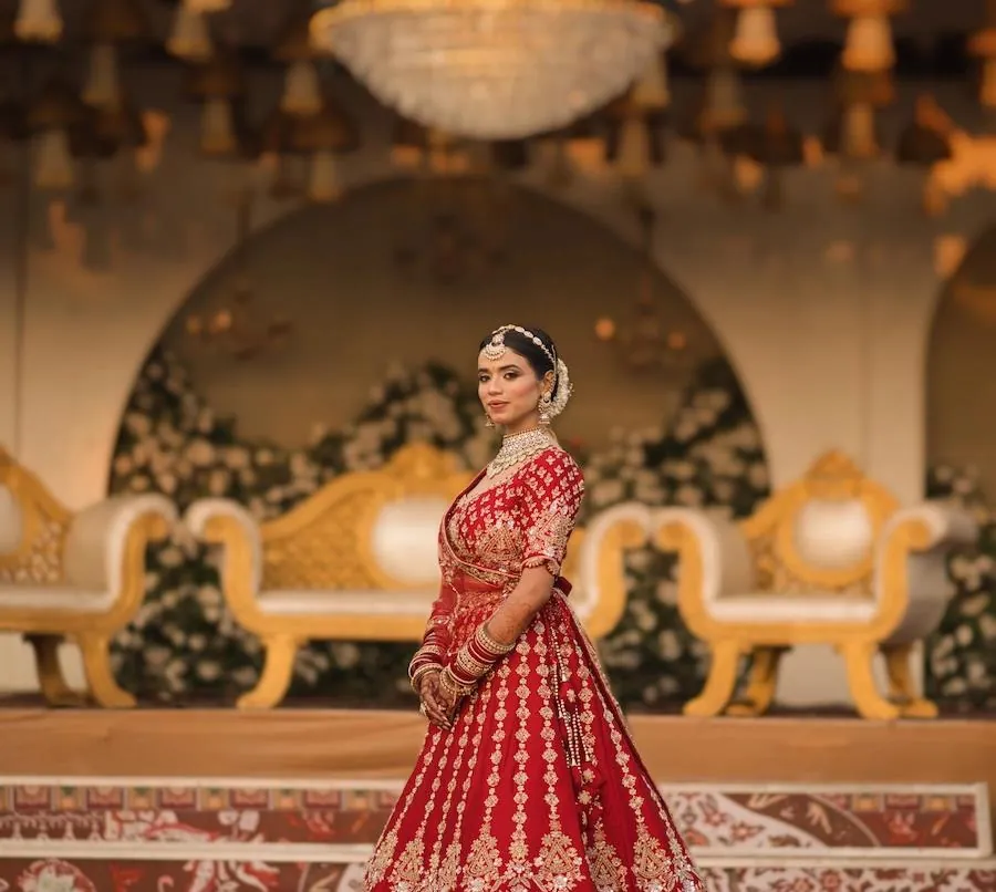 Bride in an elegant portrait beneath warm celebration lights